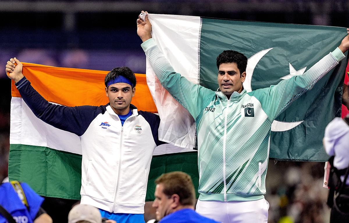 Neeraj Chopra (left) of India and Arshad Nadeem of Pakistan celebrate after the men's javelin throw final at the 2024 Paris Olympics.