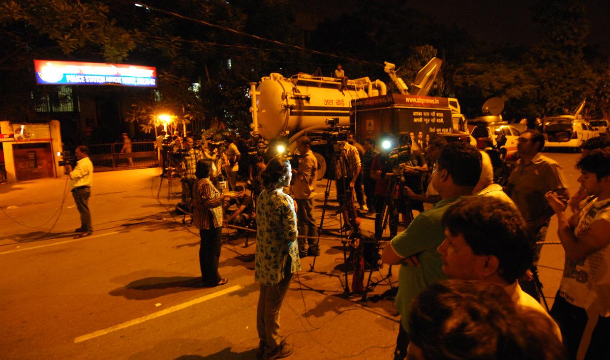 Mediapersons outside the Ashok Vihar police station in Delhi on August 18, 2012, where former Haryana Minister Gopal Kanda surrendered in connection with the Geetika Sharma suicide case. 