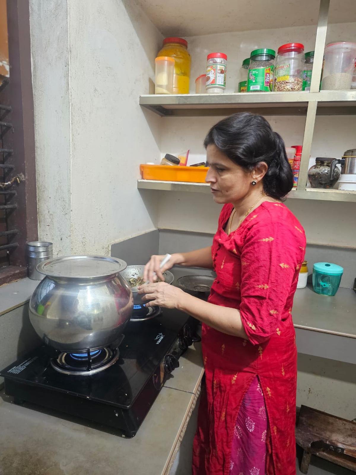 Ashalatha A, who is visually challenged, working in her kitchen