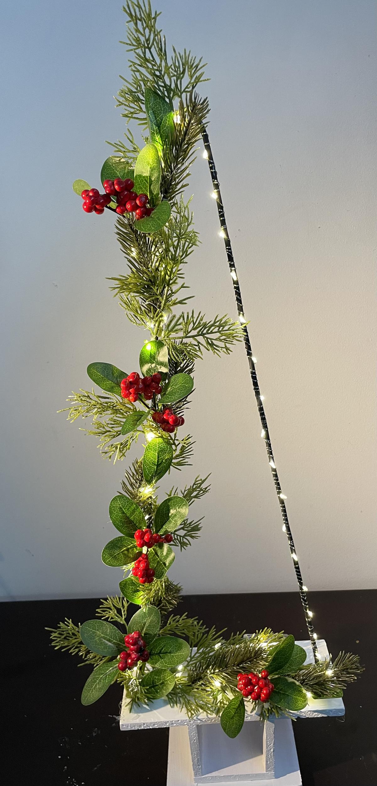 Artificial flower arrangements and Christmas-themed articles made by Leena George. 