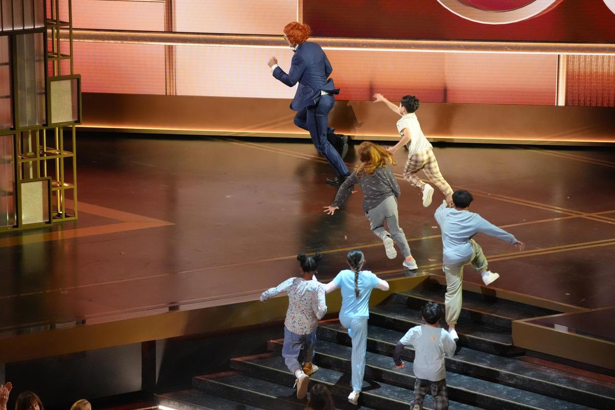 Host Conan O'Brien, dressed as the character Gladys Lilly from ‘Weapons’ is chased by children during the Oscars at the Dolby Theatre in Los Angeles Host Conan O'Brien, dressed as the character Gladys Lilly from ‘Weapons’ is chased by children during the Oscars at the Dolby Theatre in Los Angeles
