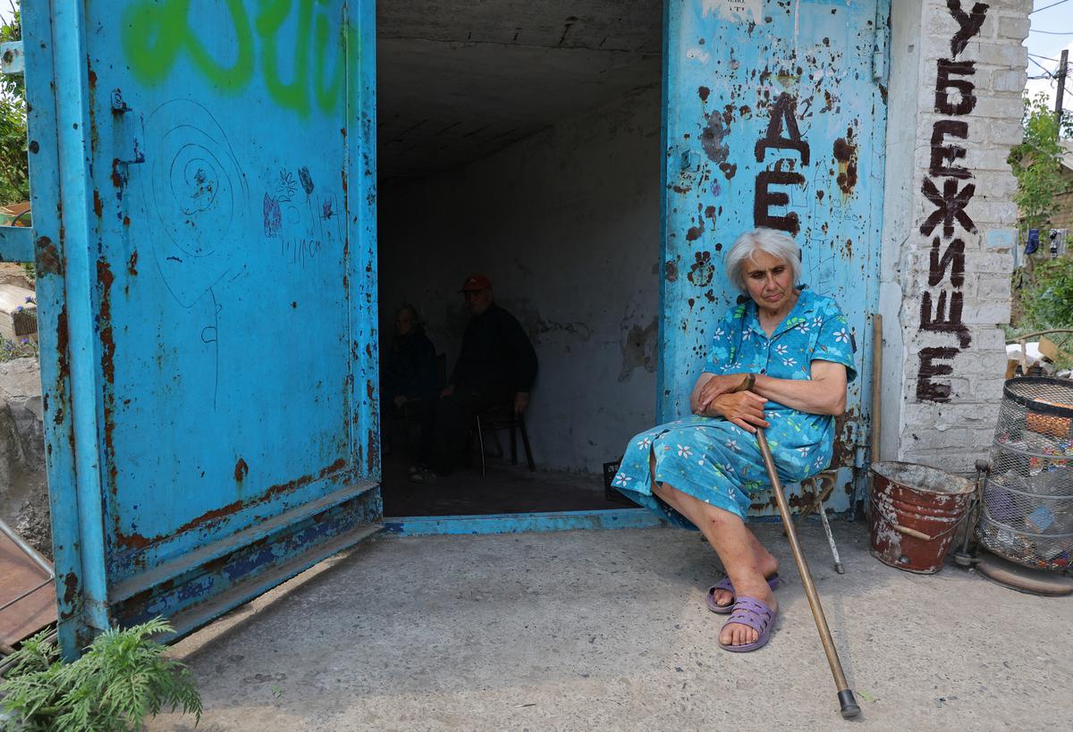 Local residents sit at the entrance to a glass factory bomb shelter during Ukraine-Russia conflict in the city of Lysychansk in the Luhansk Region, Ukraine on July 5, 2022. 