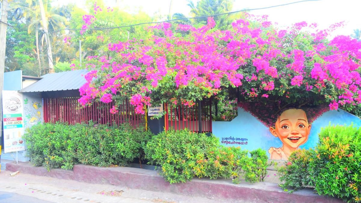 Wall art in Thiruvananthapuram featuring bougainvillea blooms merging into a smiling face grabs eyeballs