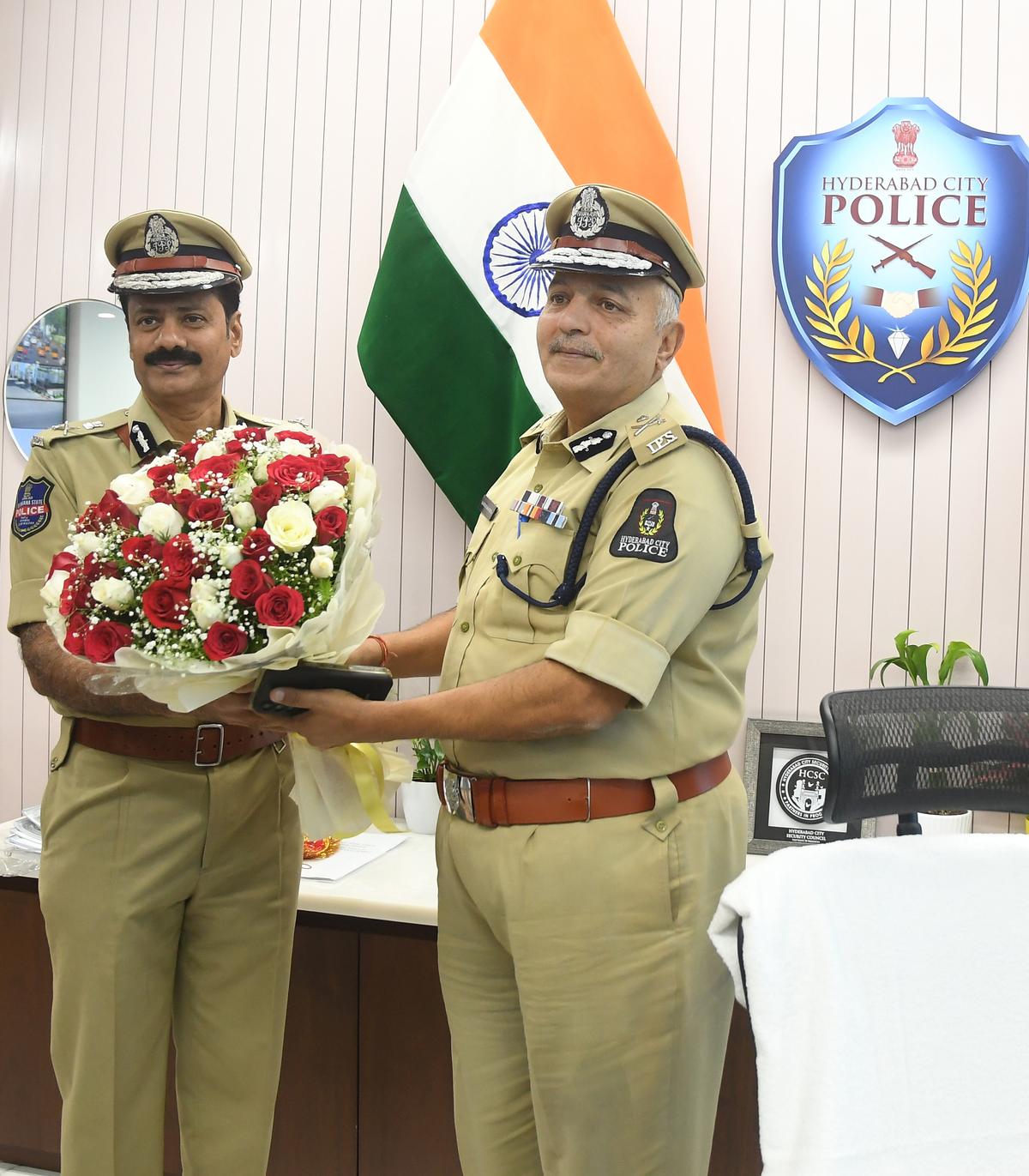 Outgoing police commissioner Sandeep Shandilya (right) welcomes the newly appointed Hyderabad City police commissioner Kothakota Sreenivasa Reddy as he takes charge, at the ICCC, Banjara Hills, in Hyderabad on Wednesday (December 13, 2023).