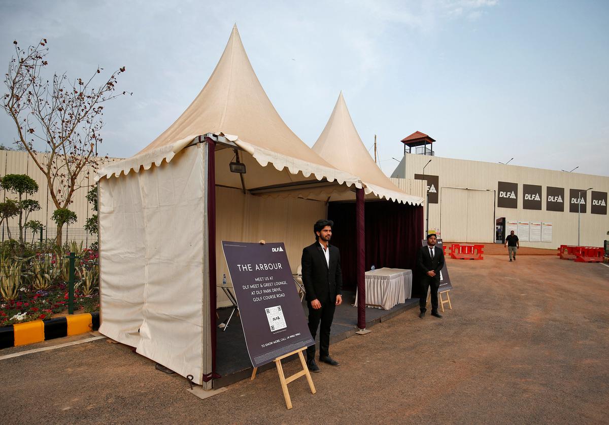 Sales representatives stand outside their kiosks inside a luxury residential project by Indian property developer DLF in Gurugram, India.