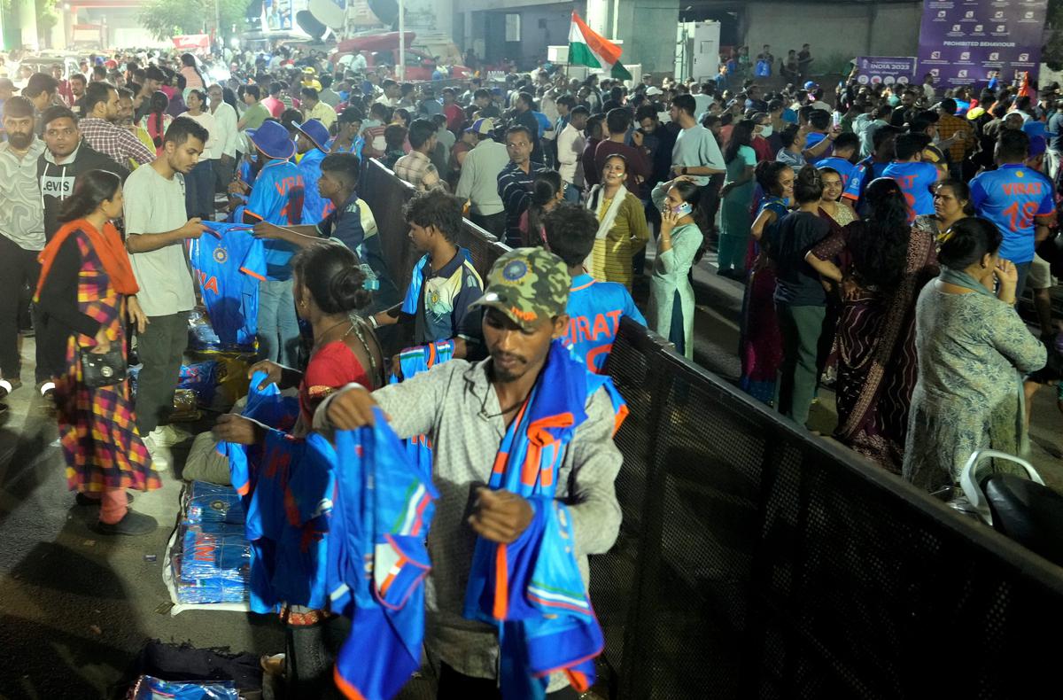 Hawkers sell cricket merchandise outside the Narendra Modi Stadium on the eve of the ICC Men’s Cricket World Cup 2023’s final match between India and Australia, in Ahmedabad, Saturday, Nov. 18, 2023. 