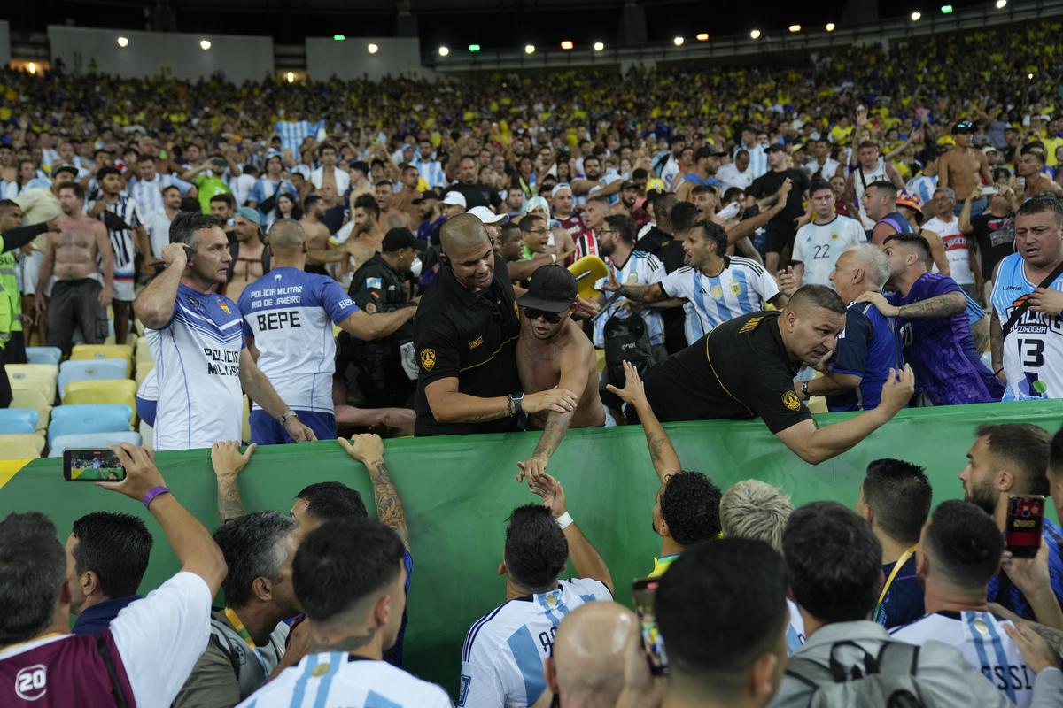Players of Argentina try to calm the crowd after a fight between Brazilian and Argentinian fans broke out in the stands prior to a qualifying soccer match for the FIFA World Cup 2026 at Maracana stadium in Rio de Janeiro, Brazil, on November 21, 2023.
