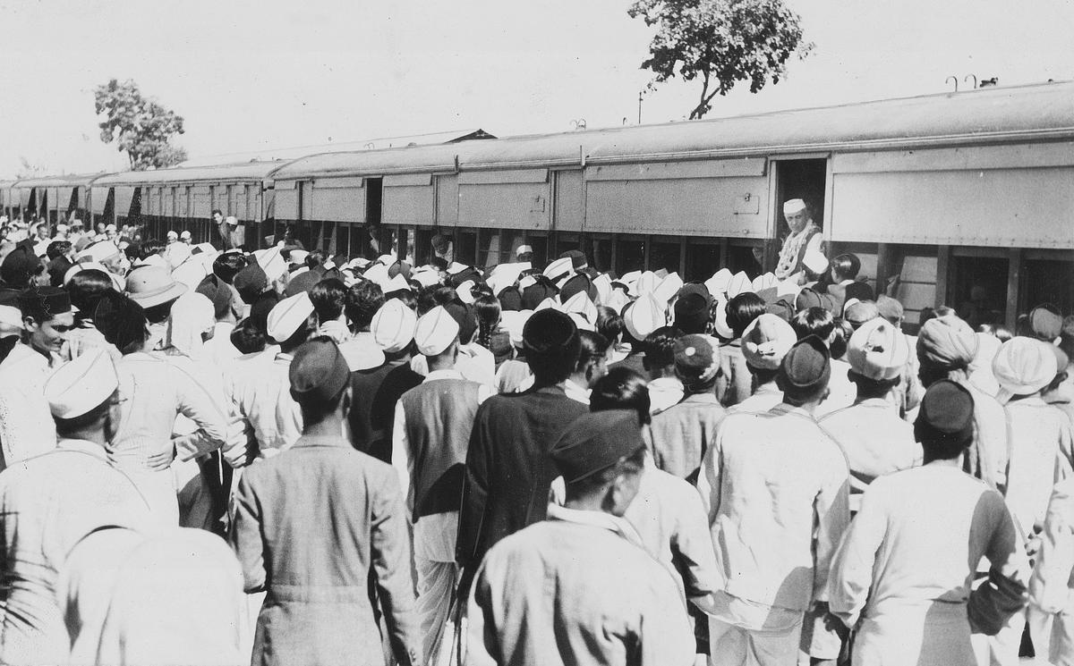 People from a nearby village gather at the railway station to catch a glimpse of Jawaharlal Nehru as his train halts at Balsara on the way to Bardoli.  