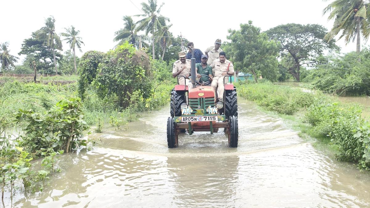 Police arrange pickets as flood water enters villages in Agency areas of Eluru district in Andhra Pradesh