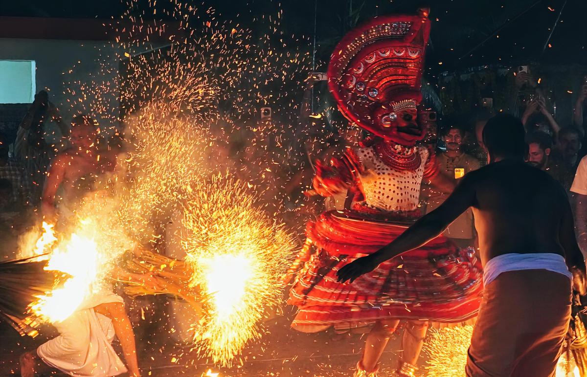 Gurukkal Theyyam amidst embers