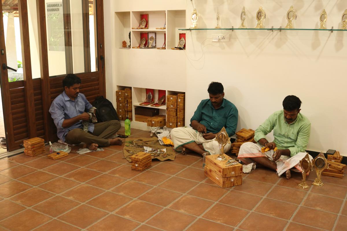 Artisans working on the Aranmula mirror at Kerala Arts and Crafts Village, Kovalam in Thiruvananthapuram