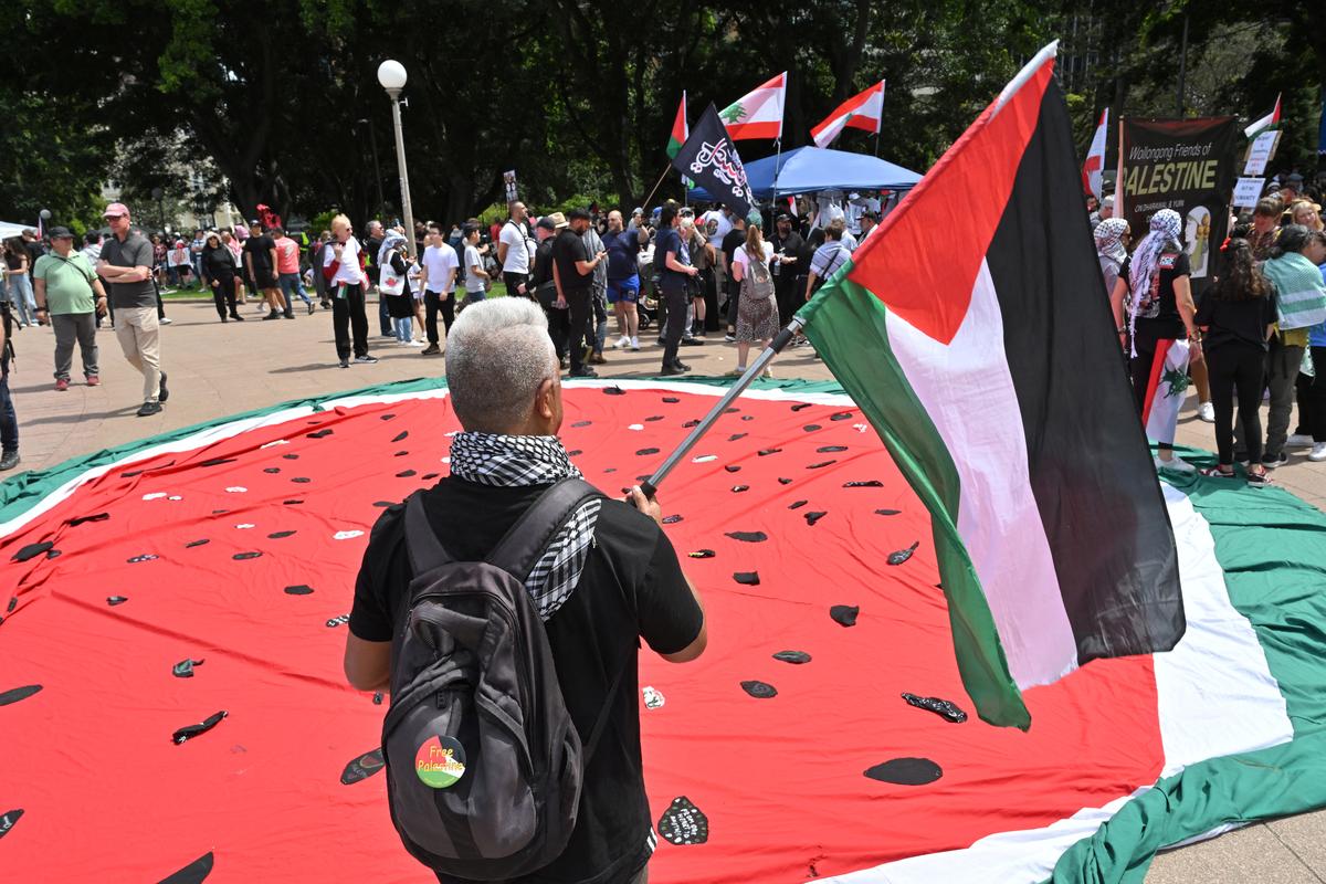 A protester waves a flag during a rally in support of Palestinians in Sydney, Australia, October 6, 2024. 