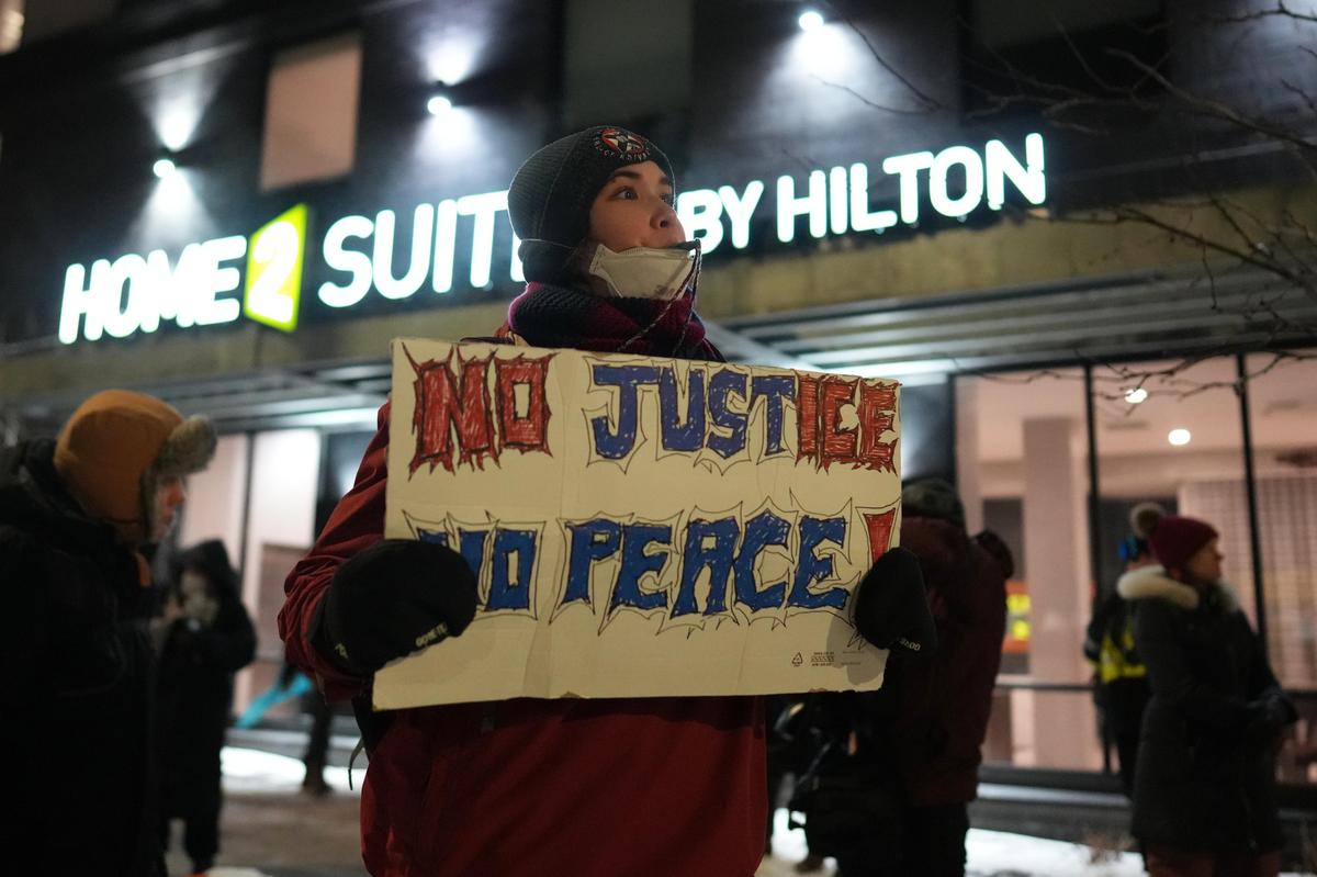 A protester blows a whistle during a noise demonstration in front of a hotel where they believe ICE agents are staying in response to federal immigration enforcement operations in the city on Sunday, Jan. 25, 2026, in Minneapolis. 
