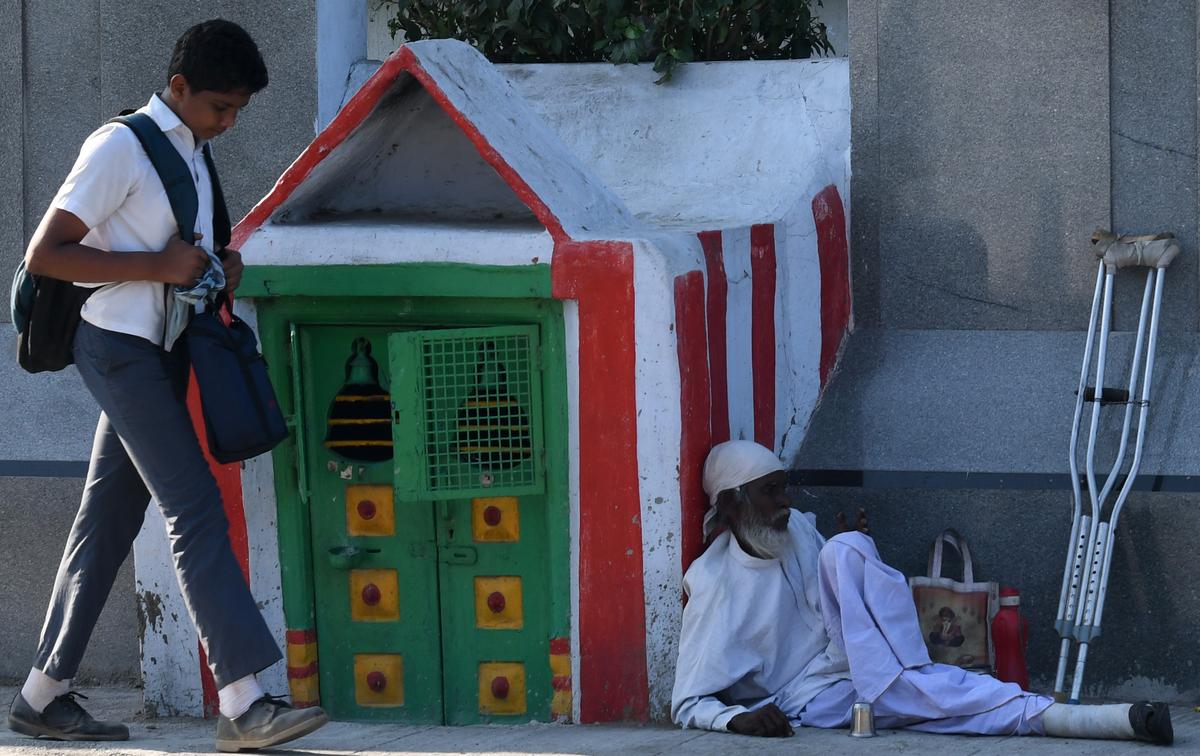 An old man waits for alms by the roadside in Chennai. 