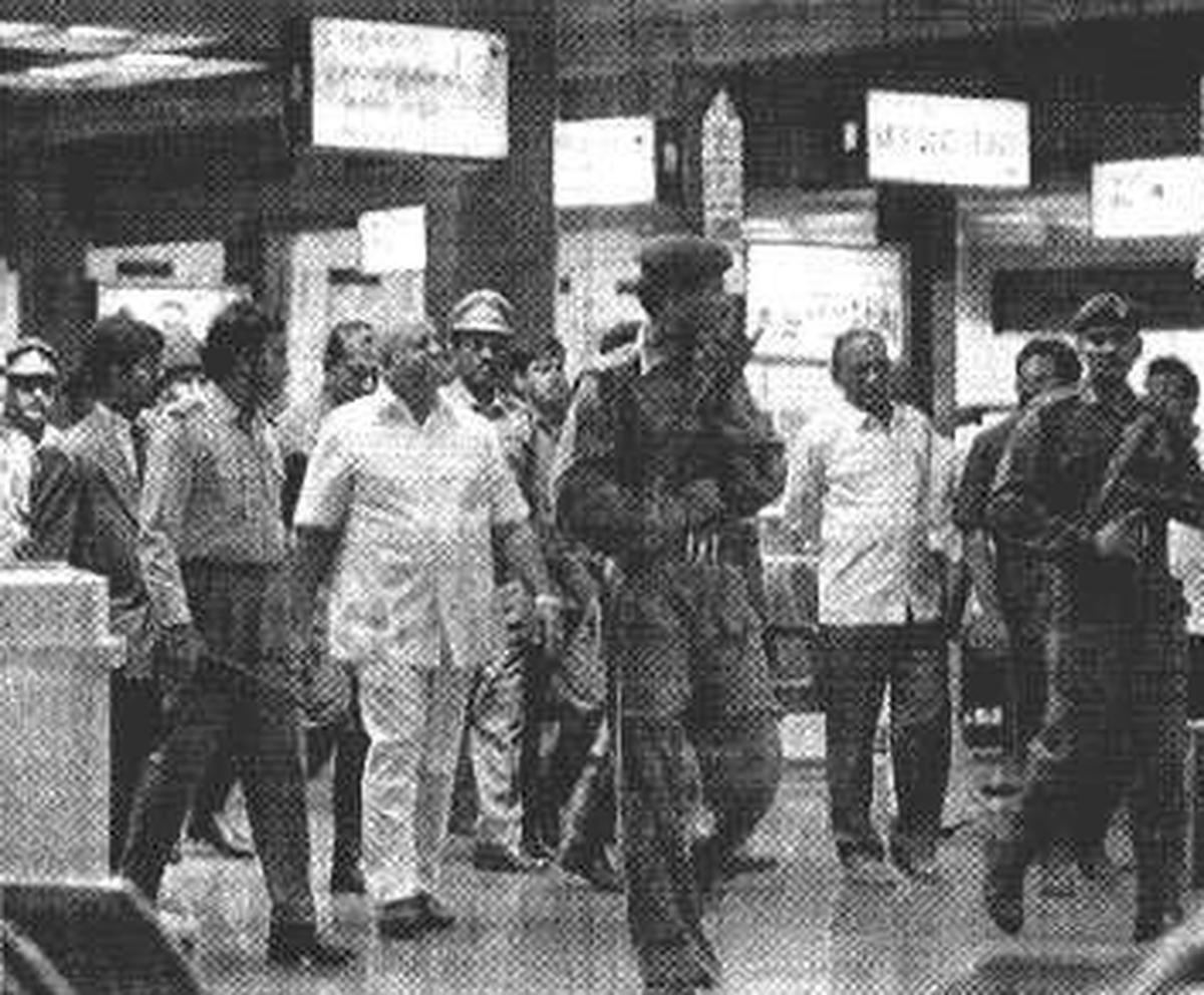 Then Chief Election Commissioner of India, T.N. Seshan, walking through the lounge of the Madras airport on November 27, 1994 surrounded by security personnel, as AIADMK party cadres wait outside with black flags.