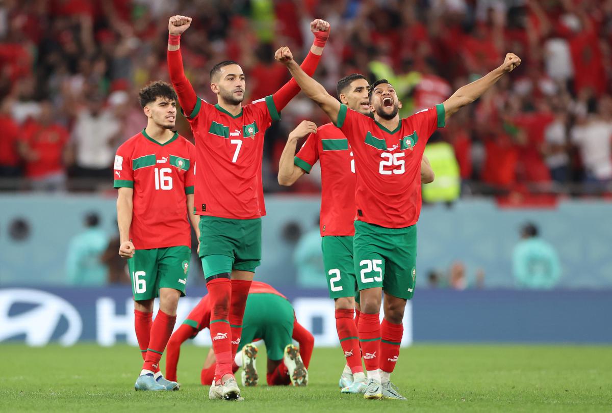 Hakim Ziyech and Yahya Attiat-Allah of Morocco celebrate after the penalty shootout in the FIFA World Cup Qatar 2022 Round of 16 match between Morocco and Spain