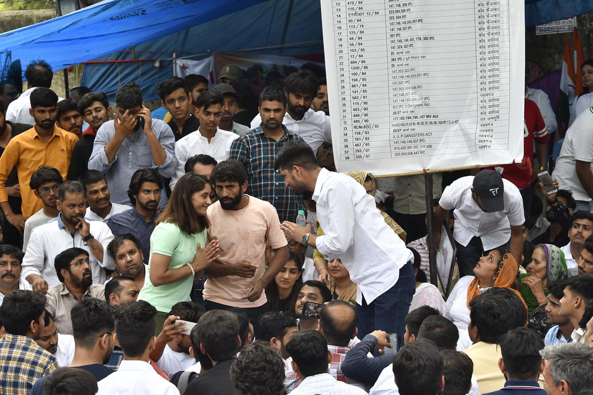 Wrestlers Bajrang Punia, Vinesh Phogat with Rajasthan University Students Union President Nirmal Choudhary during their sitting on a dharna against the Wrestling Federation of India Chief Brijbhushan Sharan Singh at Jantar Mantar in New Delhi on April 28, 2023. 