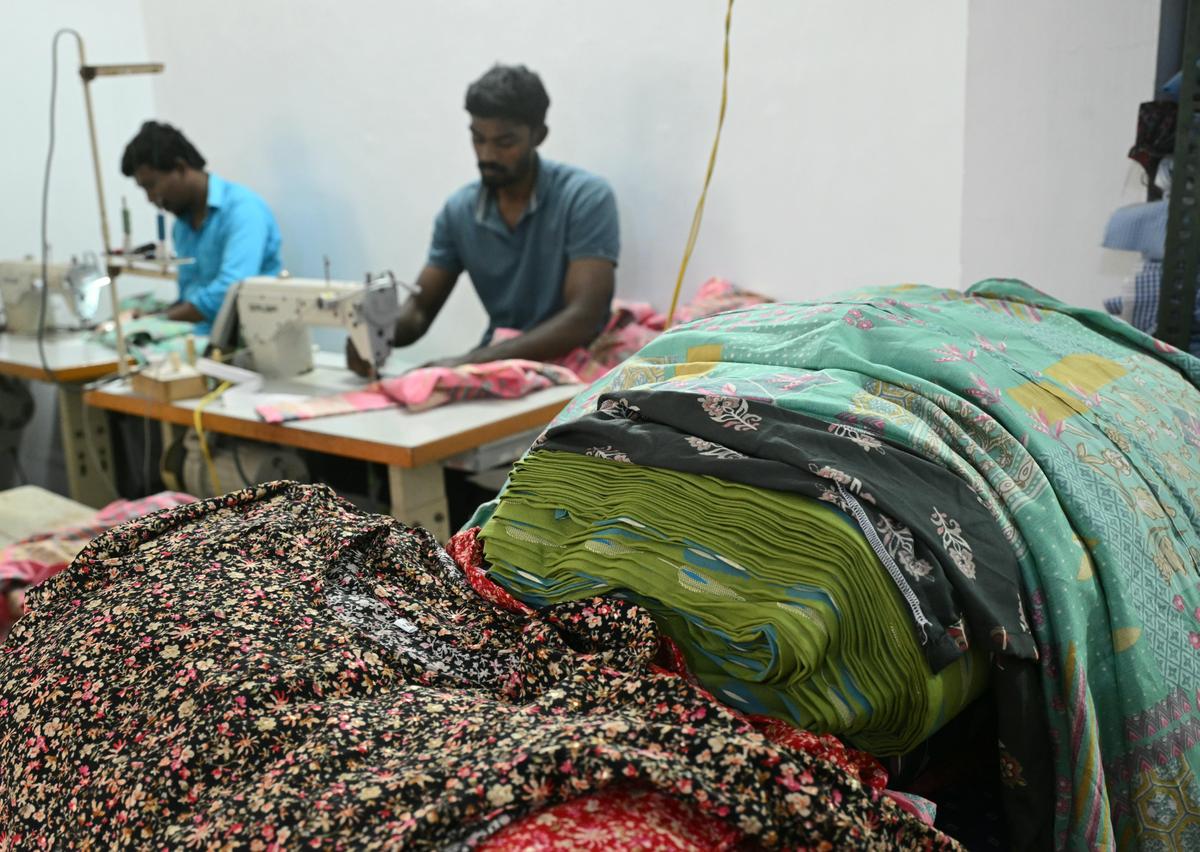 Tailors stitching garments at ready made cloth manufacturing unit in Puthiyamputhur in Thoothukudi District. 