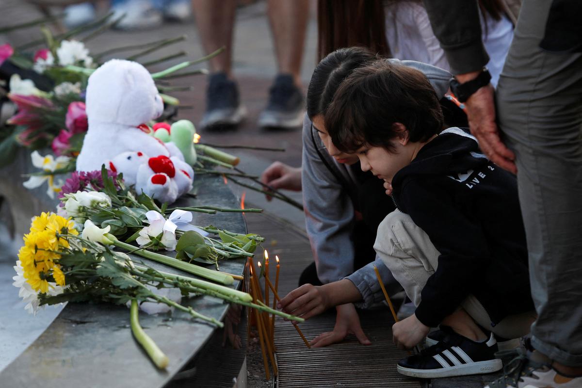 Children light up candles to pay tribute to victims of Belgrade school mass shooting in Podgorica on May 5, 2023. 