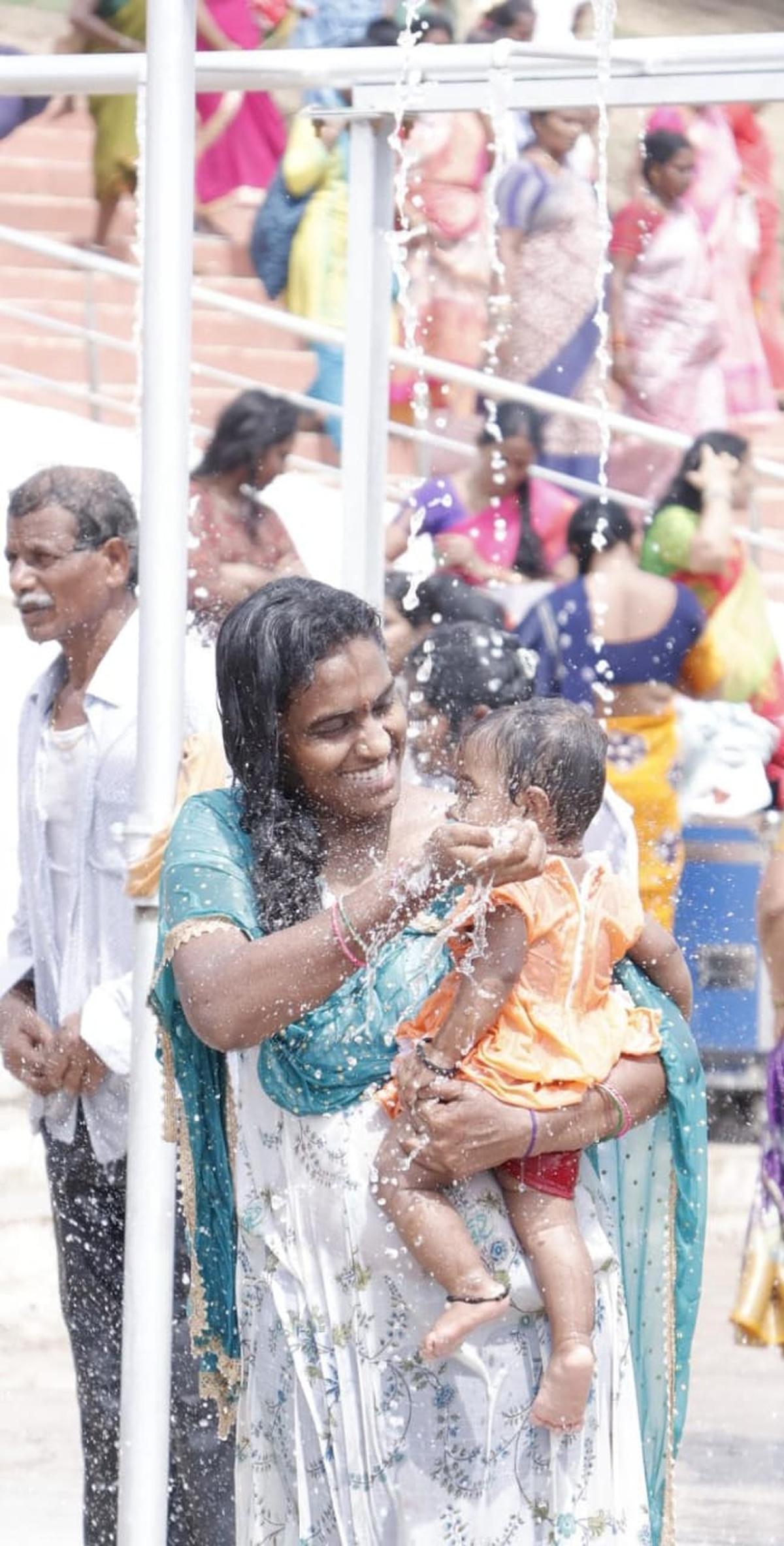 A woman with her baby after taking a holy dip at the Saraswati Ghat in Kaleshwaram. A woman with her baby after taking a holy dip at the Saraswati Ghat in Kaleshwaram.