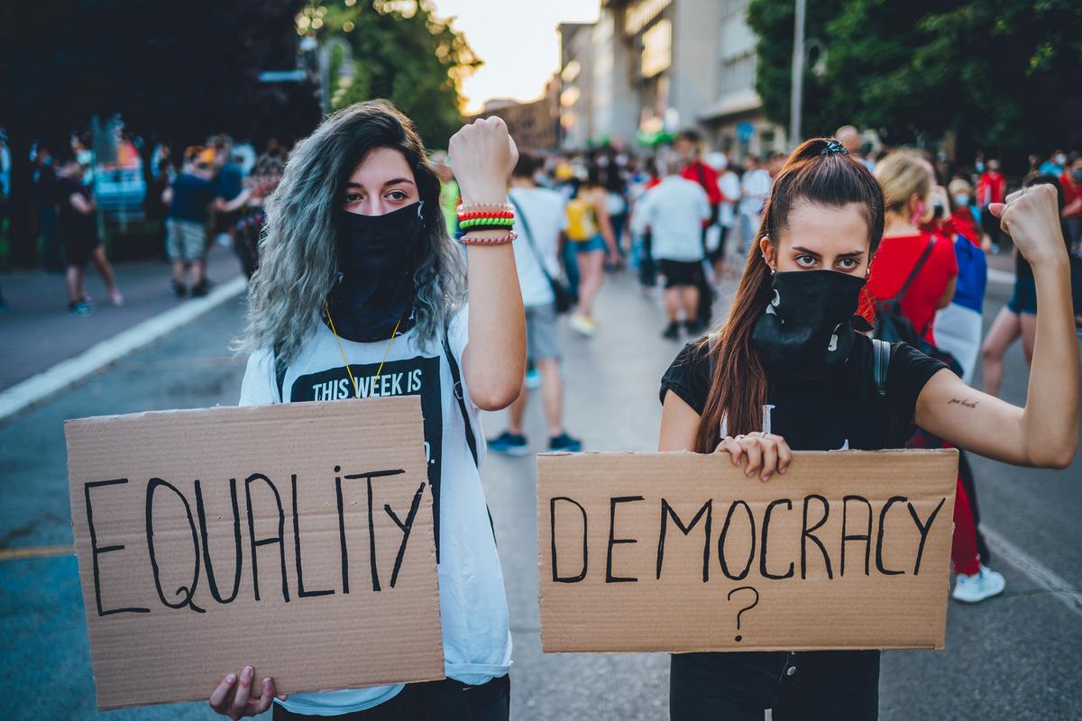 Two women at a rally seeking equal rights.