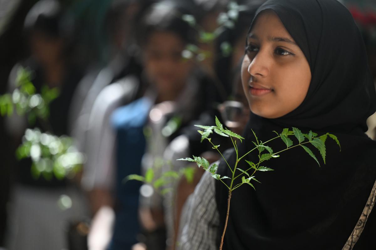 Students hold saplings as they attend a special assembly during Enviroment Day celebrations at Government Girls’ High School, Ernakulam, on Thursday. 