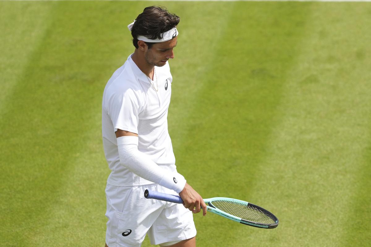 Lorenzo Musetti of Italy reacts after losing his first round men’s singles match against Nikoloz Basilashvili of Georgia at the Wimbledon Tennis Championships in London, Tuesday, July 1, 2025.