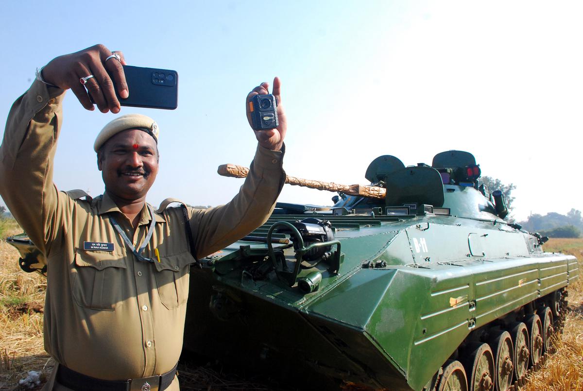 A security personnel from Ordinance Factory Medak taking a selfie with a BMP-II Infantry Combat Vehicle in the background, near Malkapur lake, Sangareddy on December 21, 2023. 