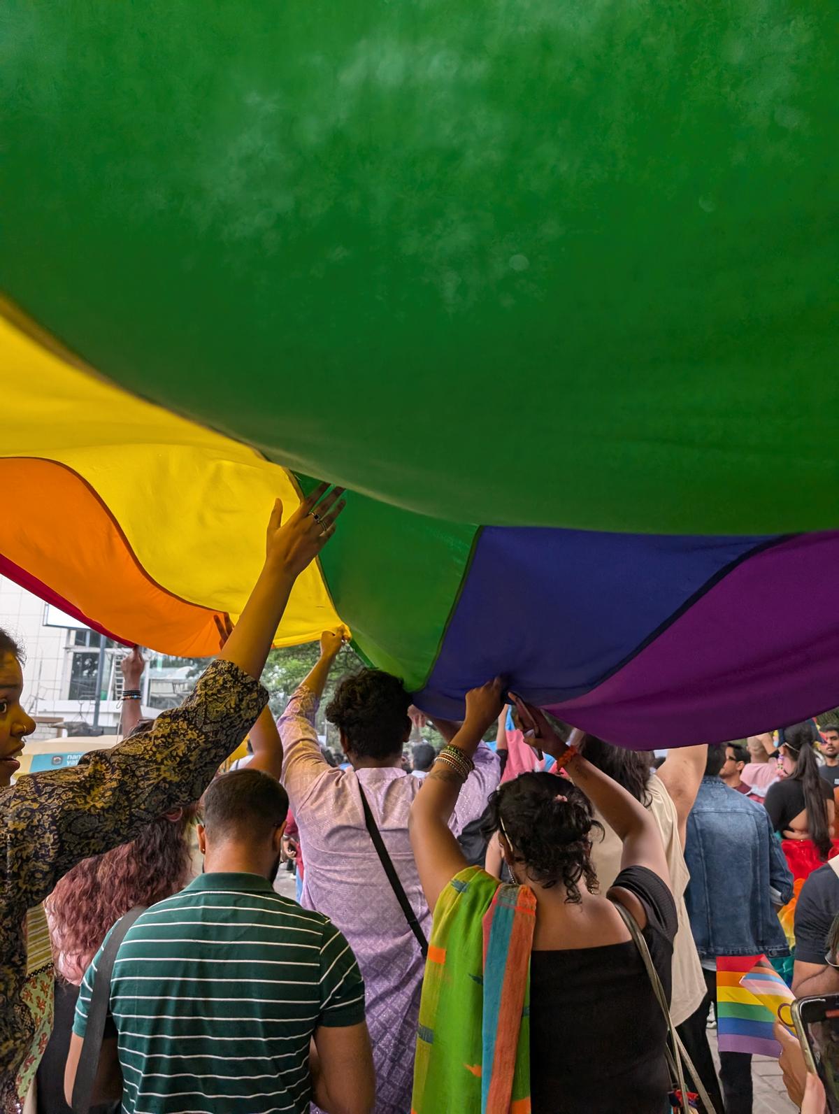 Participants holding the pride flag.