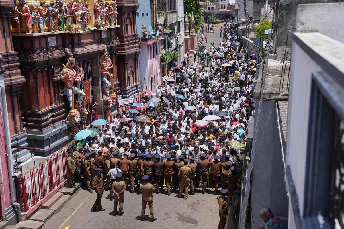 Supporters of arrested former president Ranil Wickremesinghe shout slogans during a protest out side a magistrate’s court in Colombo, Sri Lanka, Tuesday, Aug.26, 2025. 