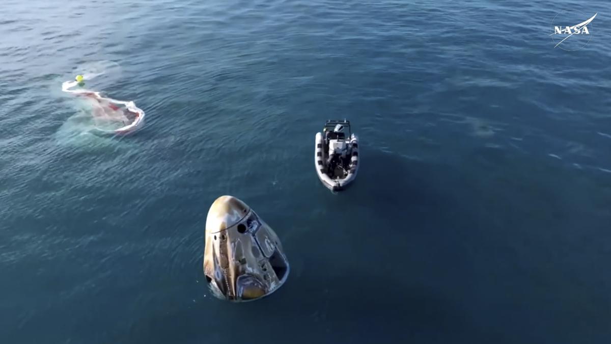 In this image taken from video provided by NASA, a SpaceX capsule floats in the Gulf of Mexico, Tuesday, March 18, 2025, after landing off the coast of Florida with NASA astronauts Suni Williams, Butch Wilmore and Nick Hague, and Russian cosmonaut Alexander Gorbunov. 