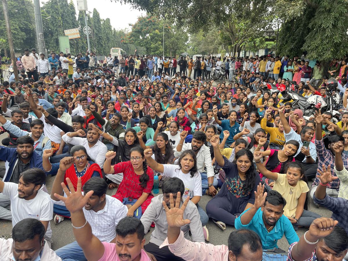 Bangalore University students block the roads inside Jnana Bharathi campus for the second day, after a student was run over by a BMTC bus on October 11, 2022. 