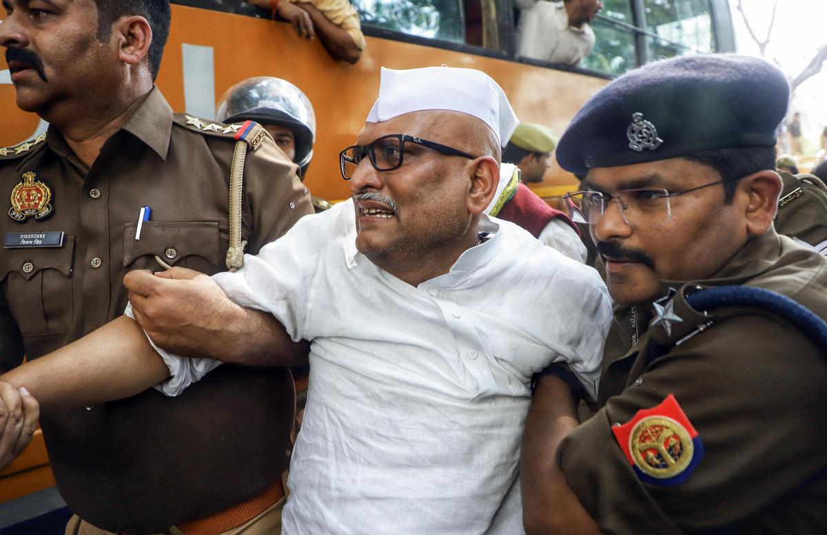 Security personnel detain Uttar Pradesh Congress President Ajay Rai during a protest demanding reinstatement of MGNREGA, in Lucknow