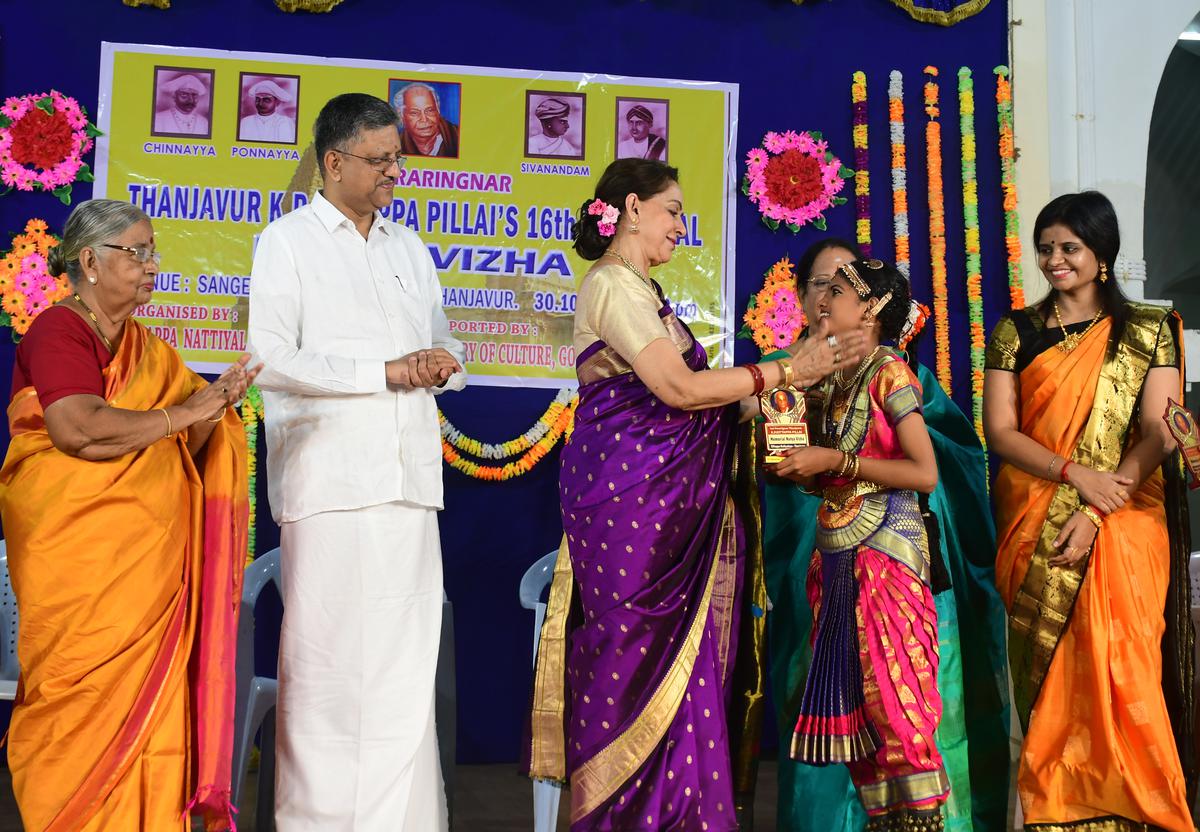 Hema Malini felicitating a young dance student. Also seen are Prince Babaji Rajah Bhonsle and Gayathri Krishnan, Collector of Tiruvarur District