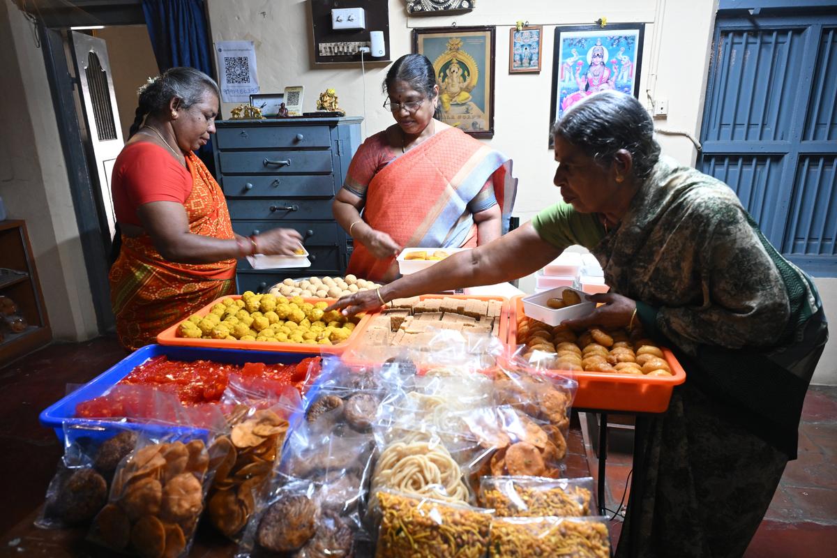 Vijayalakshmi and her team pack freshly made sweets and savouries ahead of Deepavali in Madurai. Vijayalakshmi and her team pack freshly made sweets and savouries ahead of Deepavali in Madurai.