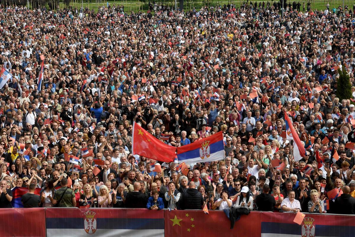 People wave Chinese and Serbian flags outside the Palace of Serbia during a welcome ceremony for Chinese President Xi Jinping in Belgrade. 
