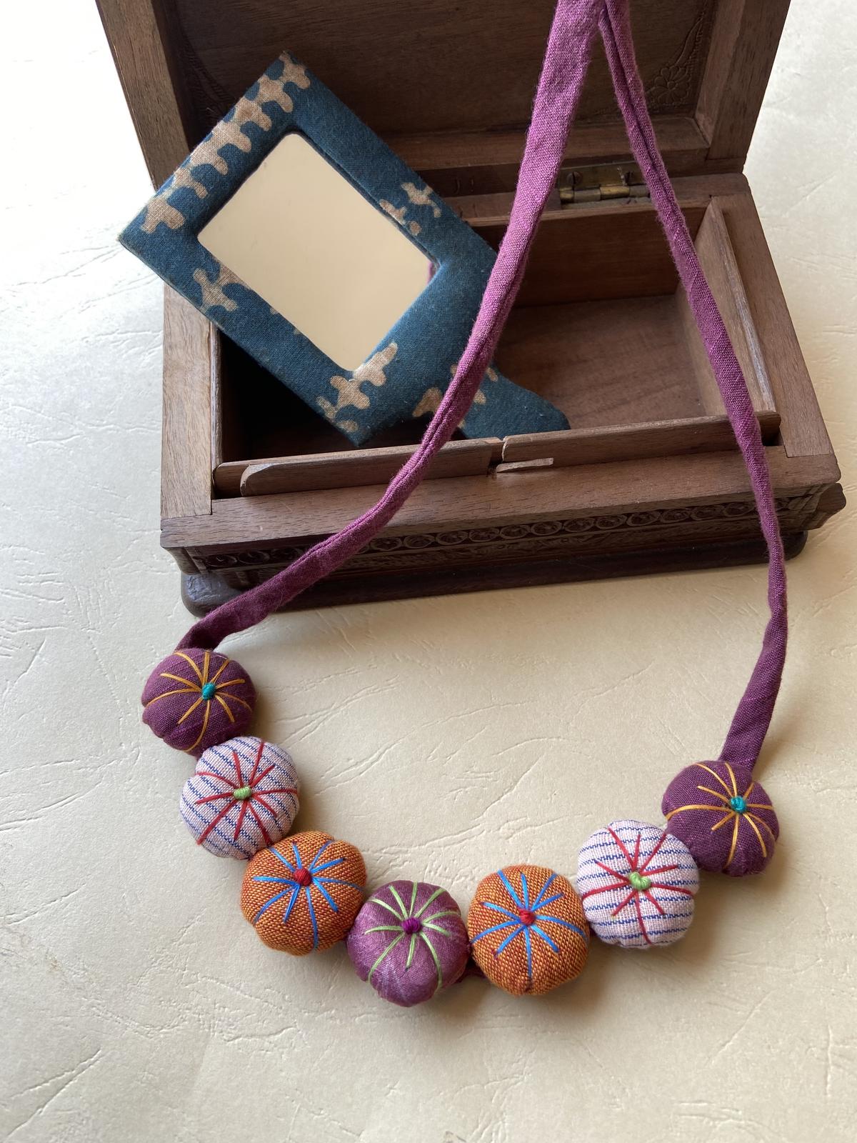 A necklace made with upcycled fabric by Oh Scrap! Madras 