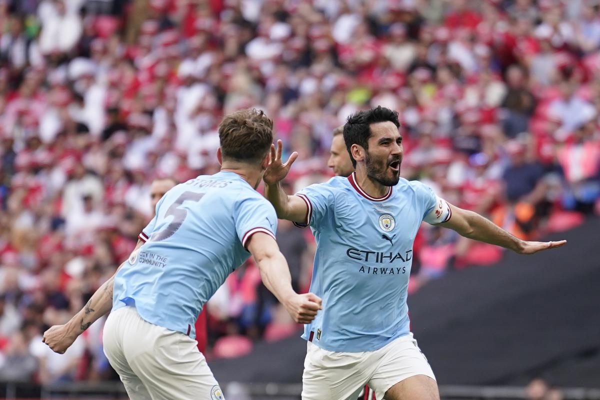 Manchester City's Erling Haaland holds the winners trophy as he celebrates  winning the English FA Cup final soccer match between Manchester City and  Manchester United at Wembley Stadium in London, Saturday, June