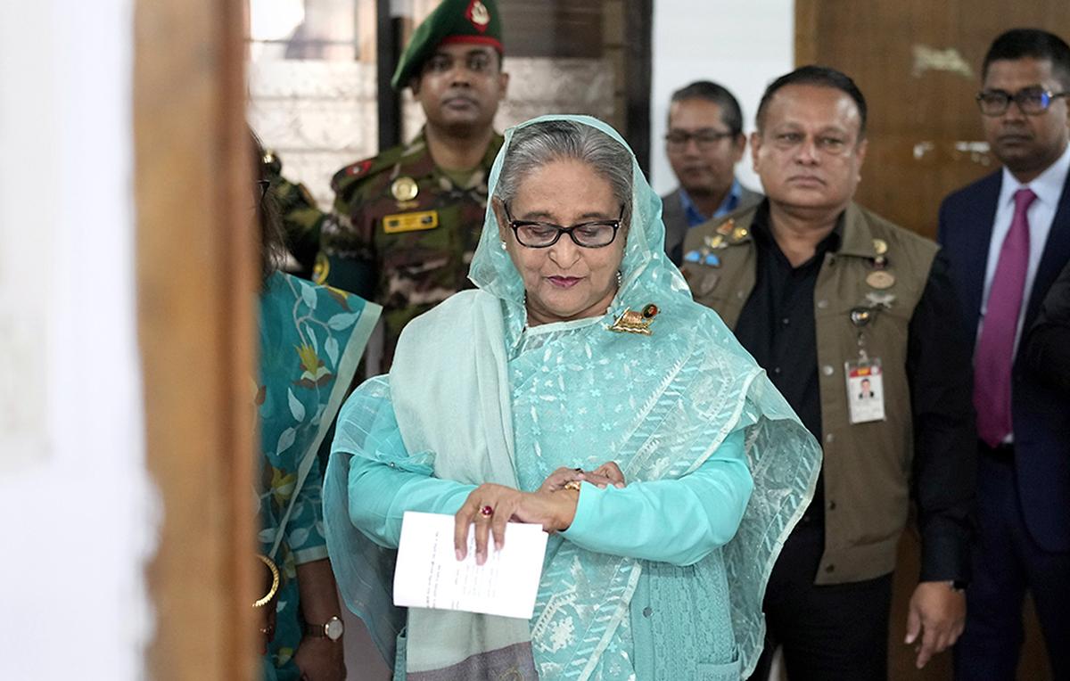 File photo: Bangladesh Prime Minister Sheikh Hasina checks her watch as she waits for the official opening time to cast her vote in Dhaka, Bangladesh, on Sunday, January 7, 2024. 