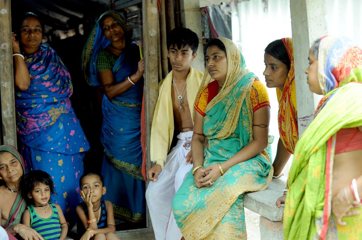 Suma Jana (with her son in green), wife of Jayant Jana, who died during a blast at an illegal firecracker manufacturing unit in Khadirul village of Purba Medinipur district in West Bengal.  