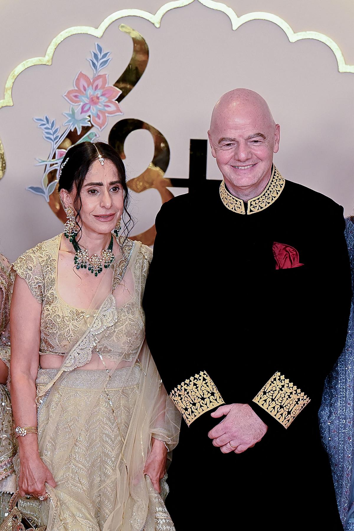 FIFA President Gianni Infantino (R) poses with his wife Leena Al Ashqar for photos as they arrive to attend the wedding ceremony of billionaire tycoon and Chairman of Reliance Industries Mukesh Ambani’s son Anant Ambani and Radhika Merchant in Mumbai on July 12, 2024. Socialite sisters Kim and Khloe Kardashian were among the global celebrities spotted in India on July 12 to attend a lavish three-day wedding ceremony staged by Asia’s richest man Mukesh Ambani