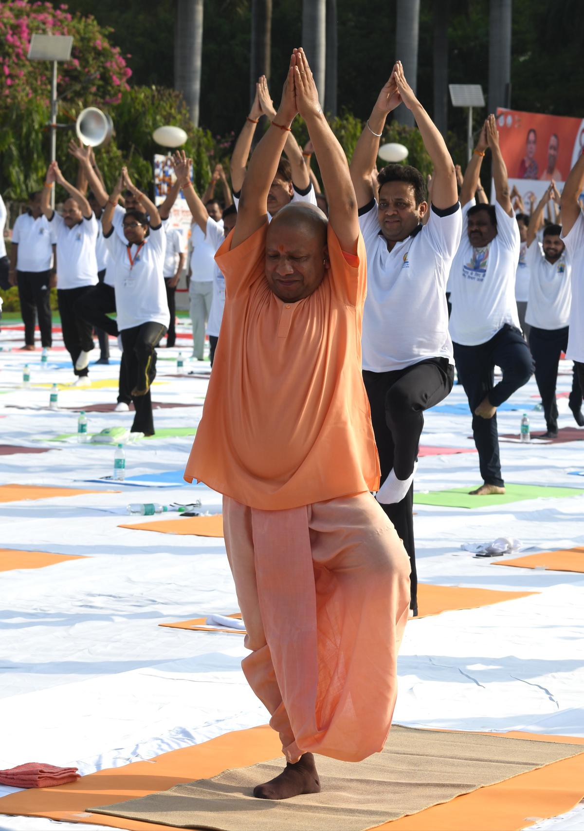 Uttar Pradesh Chief Minister Yogi Adityanath and others performing yoga during the 8th International Yoga Day celebration at Raj Bhawan, in Lucknow on Tuesday, June 21, 2022.