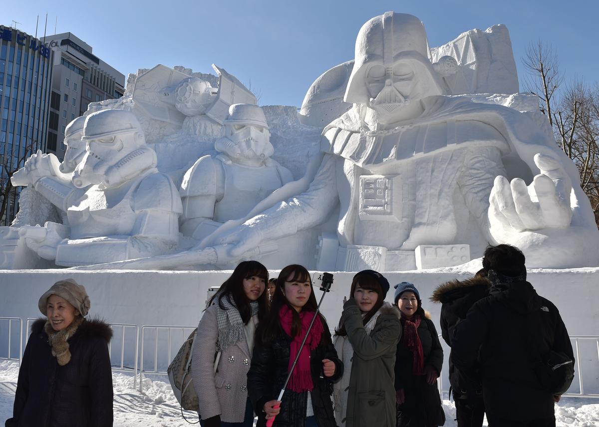 Tourists visit a large snow sculpture called the snow “Star Wars” made by the Japan Ground Self-Defense Force, Sapporo snow festival cooperation group during the 66th annual Sapporo Snow Festival.