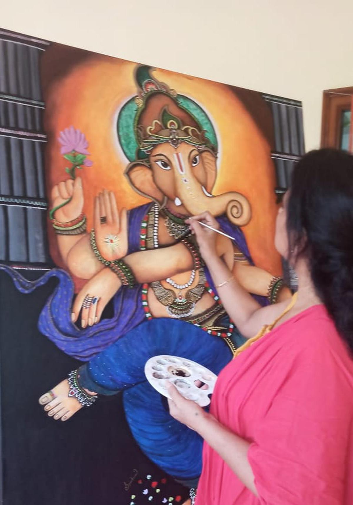 Spandana giving final touches to a Ganesha painting