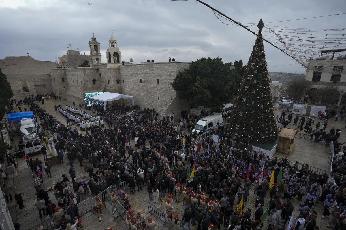 Latin Patriarch Pierbattista Pizzaballa greets worshipers in Manger Square, adjacent to the Church of the Nativity, traditionally believed to be the birthplace of Jesus Christ, in the West Bank town of Bethlehem on December 24, 2022. 