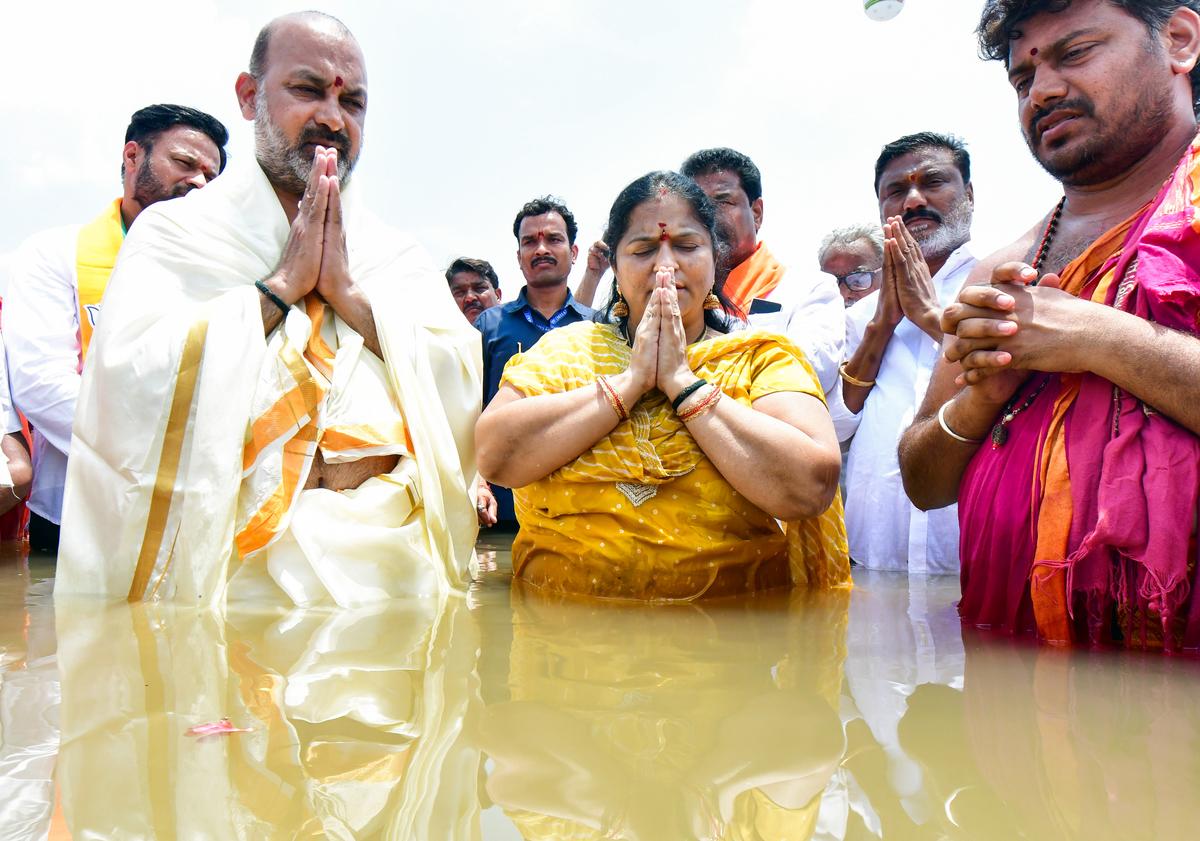 Union Minister of State for Home Affairs Bandi Sanjay Kumar and his wife Aparna a holy dip at Triveni Sangamam in Kaleshwaram on Monday. Union Minister of State for Home Affairs Bandi Sanjay Kumar and his wife Aparna a holy dip at Triveni Sangamam in Kaleshwaram on Monday.