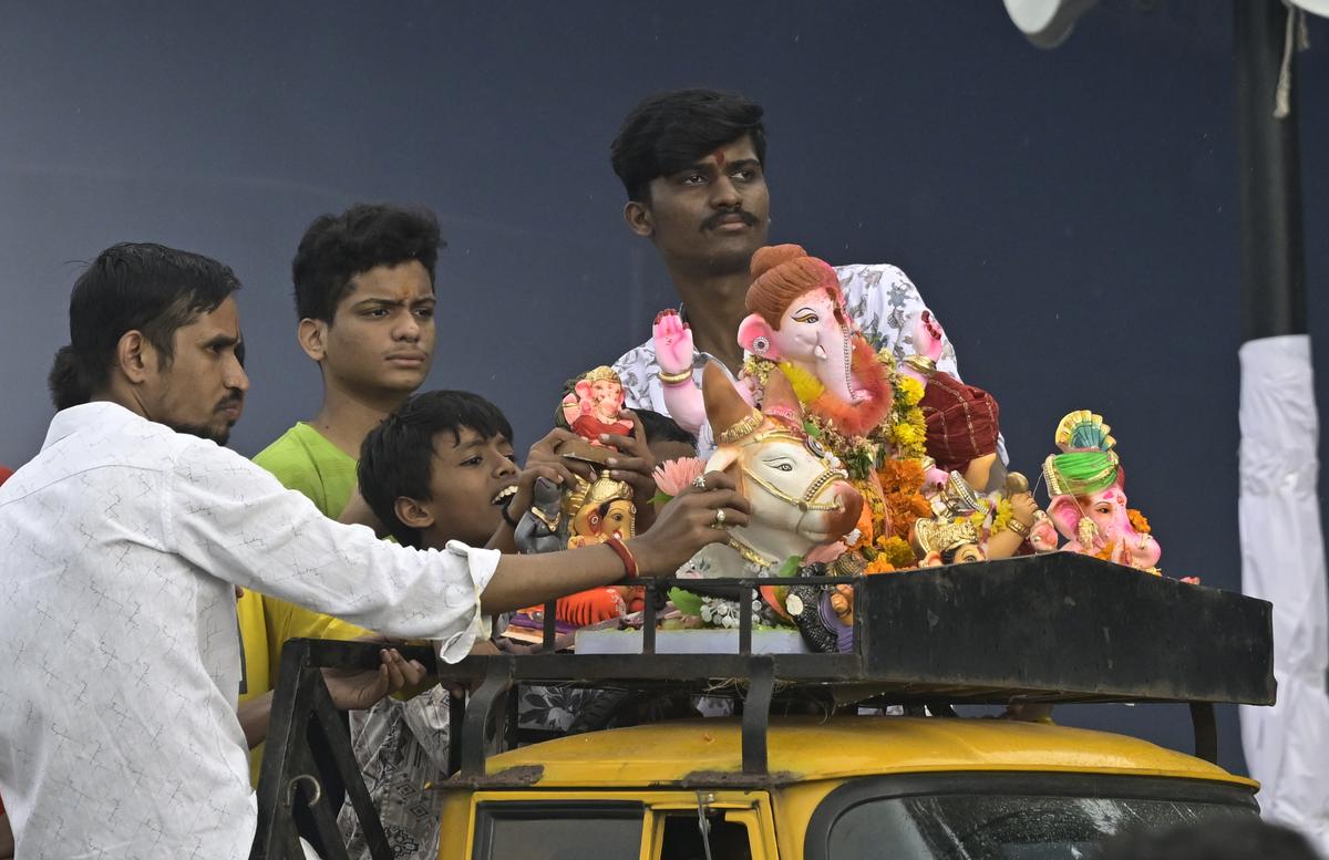 Devotees carrying an idol for immersion in Hussainsagar on the fifth day of Ganesh Chaturthi celebrations in Hyderabad on Sunday.