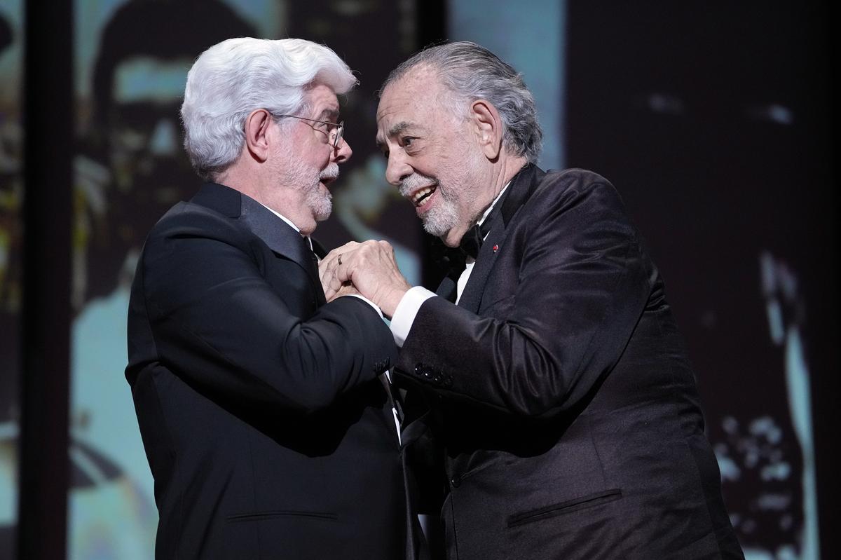 Francis Ford Coppola, right, embraces George Lucas prior to awarding him the honorary Palme d’Or during the awards ceremony of the 77th international film festival, Cannes, southern France, Saturday, May 25, 2024