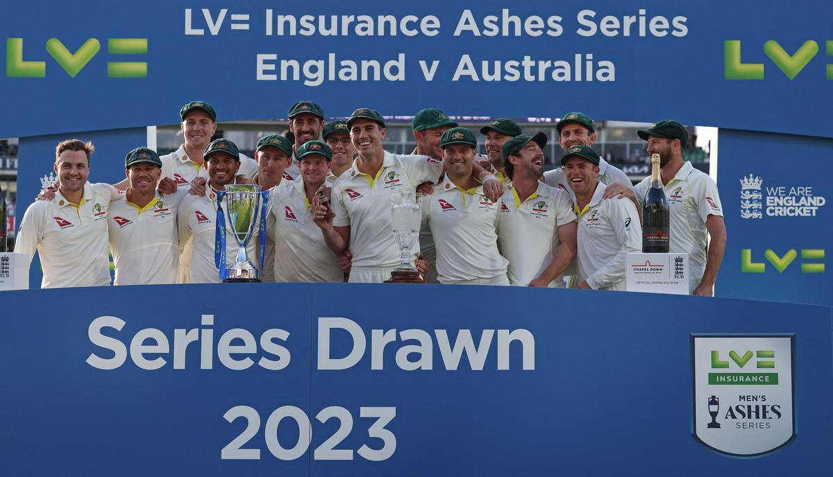 Pat Cummins holds the urn as Australia celebrates the drawn series and retains The Ashes. 