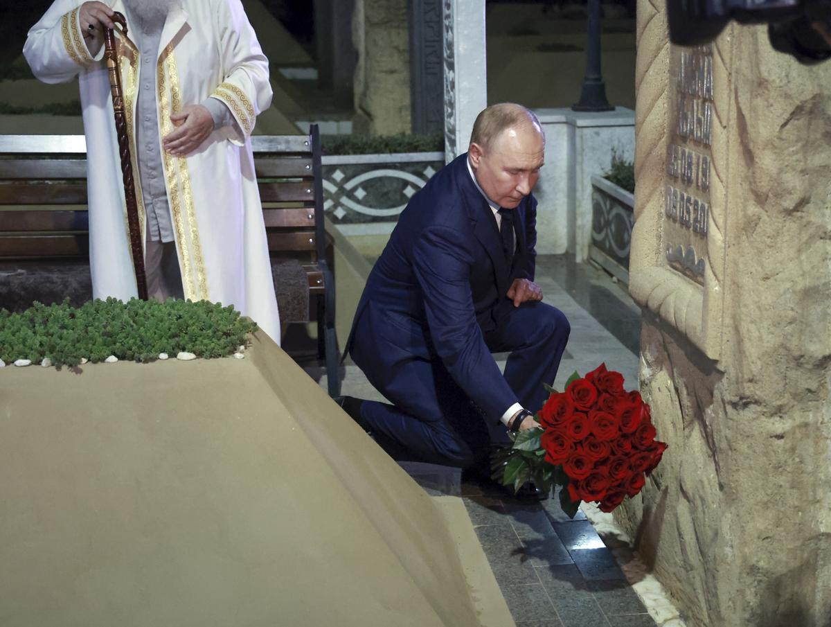 Russian President Vladimir Putin places flowers at the grave of the first president of Chechnya Akhmat-Khadzhi Kadyrov in the village of Akhmat-Yurt, Chechen Republic, Russia.